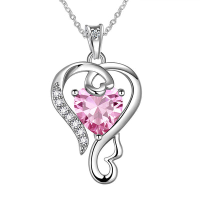 Product view showing an open silver-tone heart frame around a faceted pink center stone