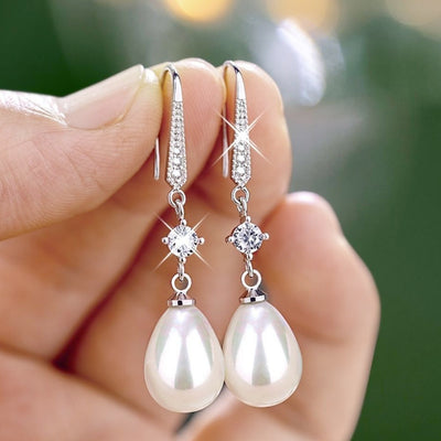 Silver-tone long earrings with pearl-like teardrop beads