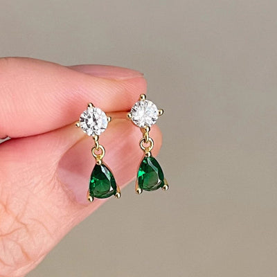 Front product view of gold tone green teardrop earrings with clear round tops