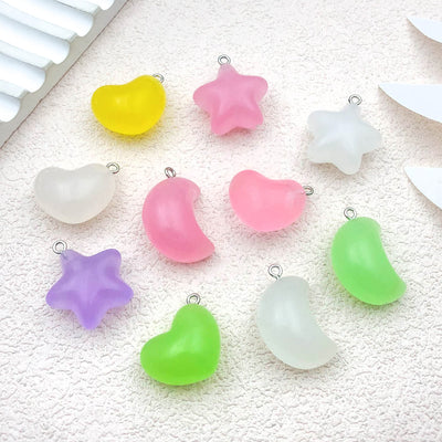 Multicolor heart and moon charms arranged on a light background