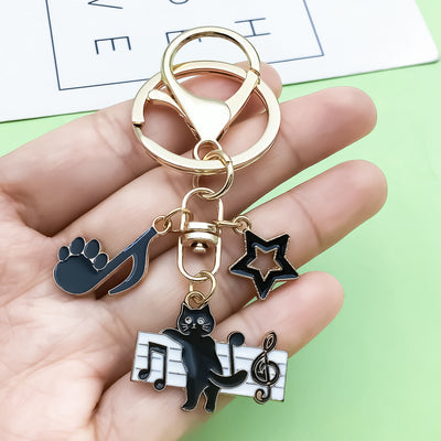 Image 1 showing a person holding two key chains with different animals.