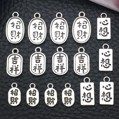 Antique silver assorted shape charms arranged on a light background