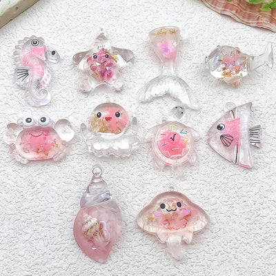 Clear seashell charms arranged on a light background