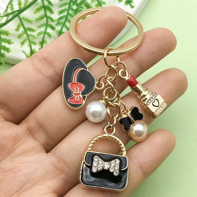 Image 1 showing a hand holding two different key chains.