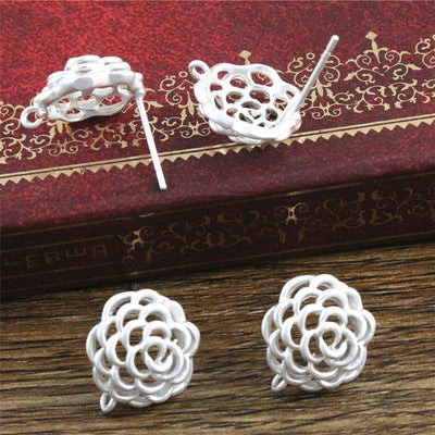 Overview of silver-tone open rose earring posts with a small attachment loop on a light background