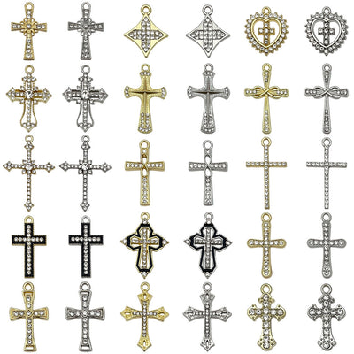 Metallic cross charms arranged on a light background