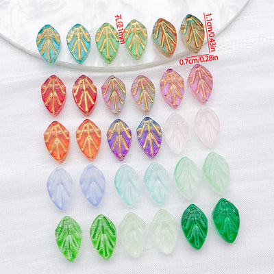 Front product photo of gold-edged translucent leaf glass bead showing the pictured design arrangement