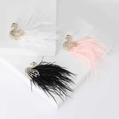 White pink and black crystal swan feather brooches group