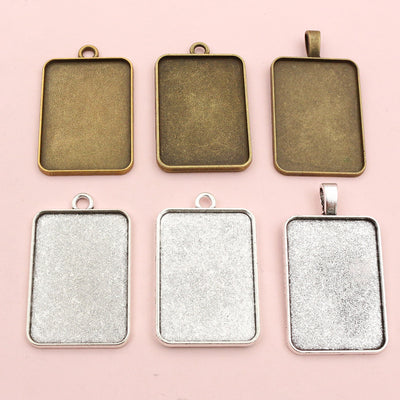 Front overview of rectangular pendant tray settings in three metal tones arranged on a light background