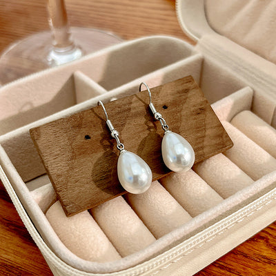 Primary supplied view of white pearl-look teardrop hook earrings