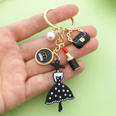 Image 1 showing a person holding a key chain with various items.