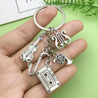 Image 1 showing a hand holding two keys in the shape of a keychain.