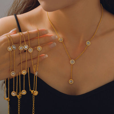 Gold rhinestone Y necklace worn with extra chains held