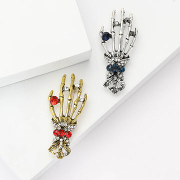 Skeleton Hand Brooch With Jeweled Ring and Ornate Cuff