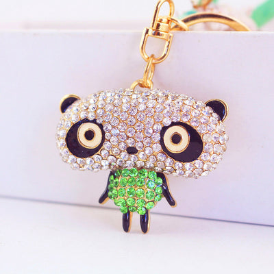 Close-up front view of the panda charm with a clear rhinestone head and green body.