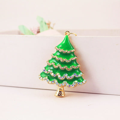 A green Christmas tree charm with iridescent rhinestone rows and gold-tone edging.