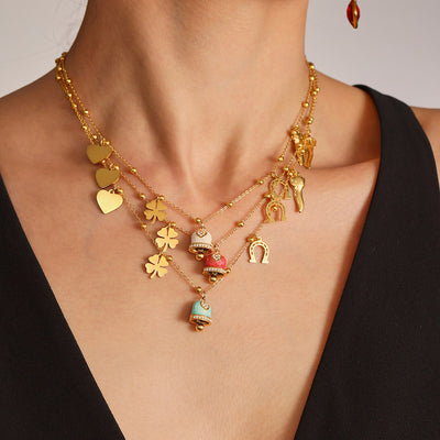 Model layered gold enamel bell charm necklaces with hearts clovers horseshoes