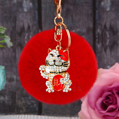 Main image 1 shows the Red Cat-Pompom option with its visible attached key hardware.