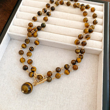 Tiger Eye Look Beaded Round Pendant Necklace With Decorative Metal Details