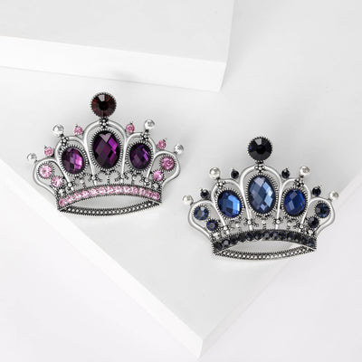 Front view of ornate jeweled crystal crown brooch in purple and blue