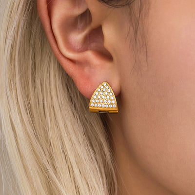Model wearing gold triangle zircon pave huggie earring