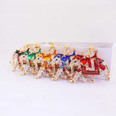 Five color variations of rhinestone elephant keychains arranged in a row.