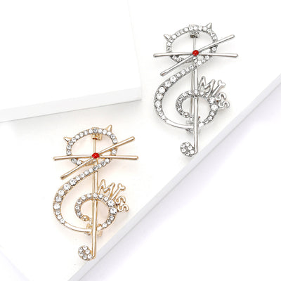 Front view of a cat perched across a crystal treble clef and music note