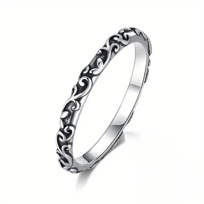 Product view showing engraved scrollwork slim band ring in gold and silver tones