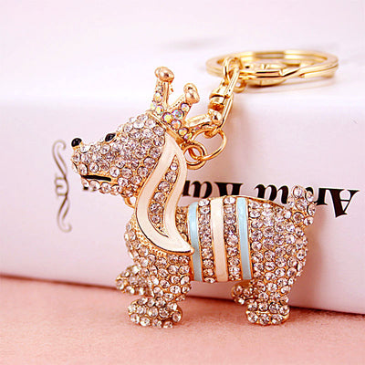 Gold-tone crowned dog keychain with blue and white stripe accents.