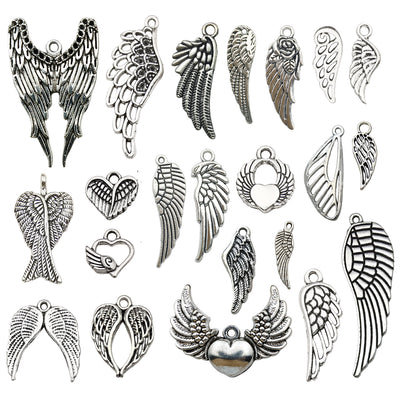 Antique silver seashell charms arranged on a light background