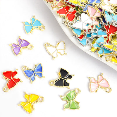 Assorted butterfly charms arranged on a white surface