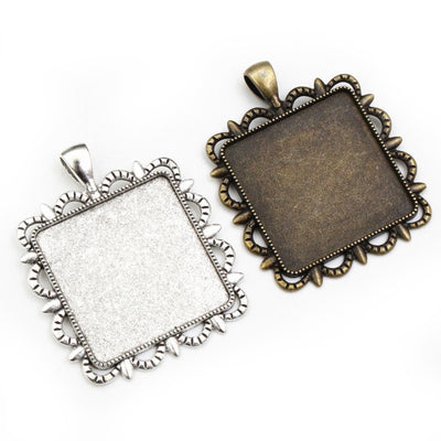 Ornate Square Cabochon Pendant Bezel Settings in Two Finishes, grouped overview on a plain background