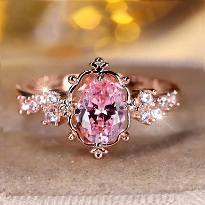 Rose gold-tone ornate ring with pink oval center