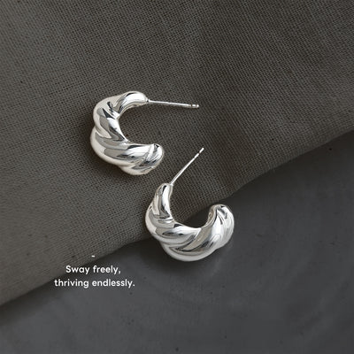 Silver-tone sculpted-twist chunky hoop studs in the first product display.