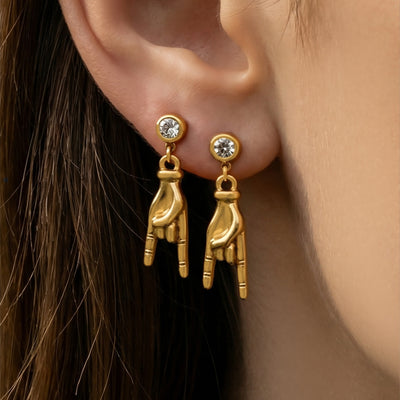 Gold rock hand gesture drop earrings worn double on ear