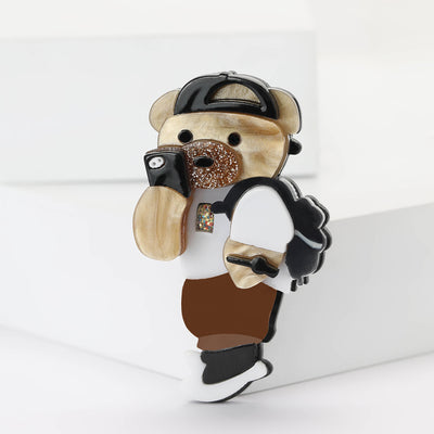 Front view of layered acrylic bear wearing a cap and holding a black and white bouquet