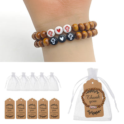 Wood cross heart bead bracelets on wrist with bags and tags