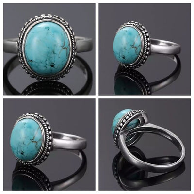 antique silver tone ring showing oval turquoise color center in a beaded frame
