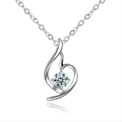 Silver swirl heart pendant with clear round stone on white background