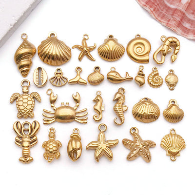 Gold-tone seahorse and shell charms arranged on a light background