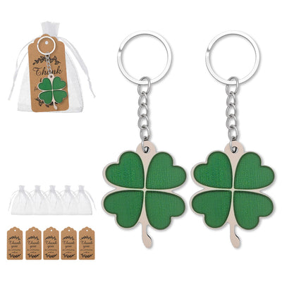 Two green wooden clover keychains with organza bags and kraft tags