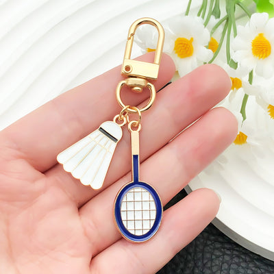 Overview showing the available color and design variations of the badminton racket and mixed sports metal clasp keychain