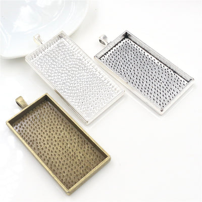 rectangular cabochon pendant trays arranged together on a white background