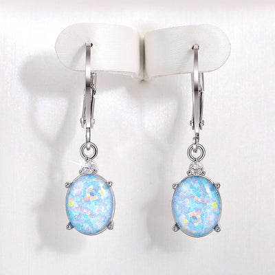 Silver light blue oval stone leverback clip earrings on white display