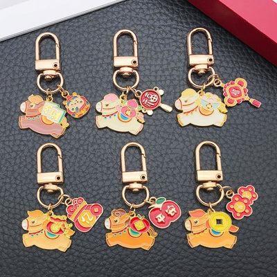 Main display of gold tone horse and lucky symbol charm keychains