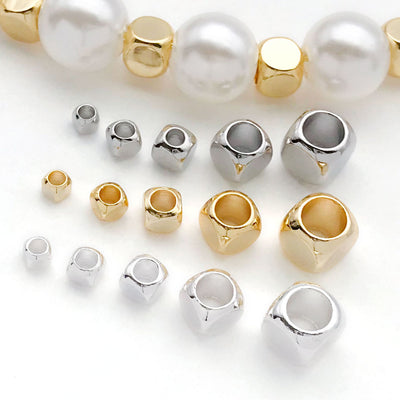 Front overview of rounded square large hole spacer beads arranged by finish and size