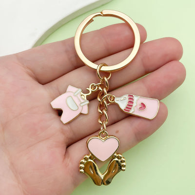 Image 1 showing a person holding up two heart shaped key chains.