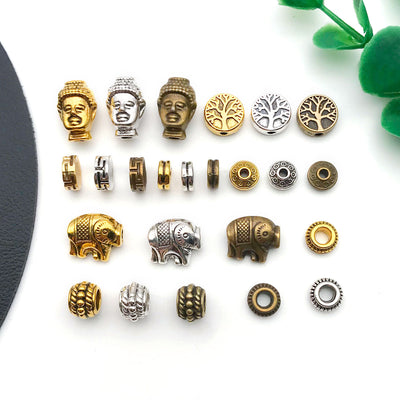 Gold-tone spacer bead beads arranged on a light background
