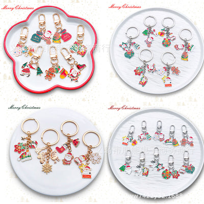 Front product photo of santa reindeer snowman and tree keychain showing the pictured design arrangement