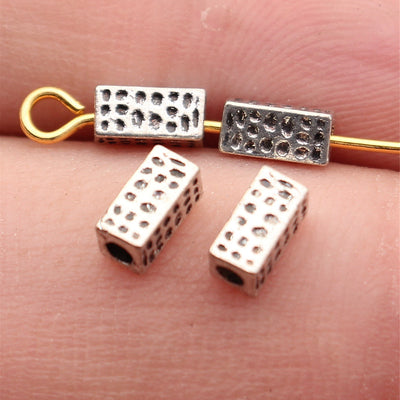 Front view of hammered tube beads in the pictured finish